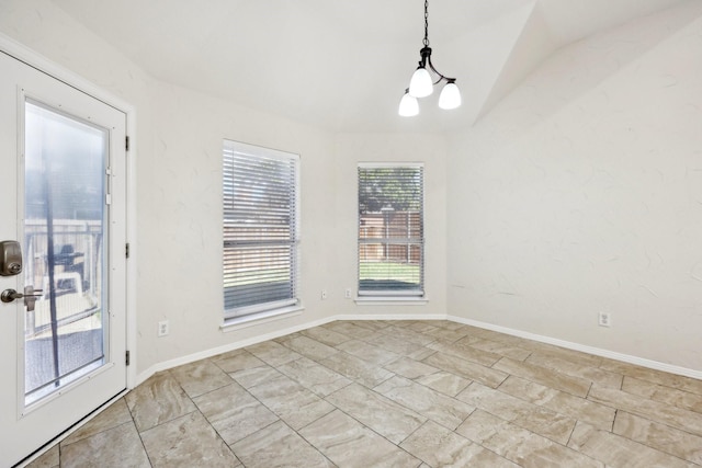 unfurnished dining area featuring lofted ceiling and an inviting chandelier