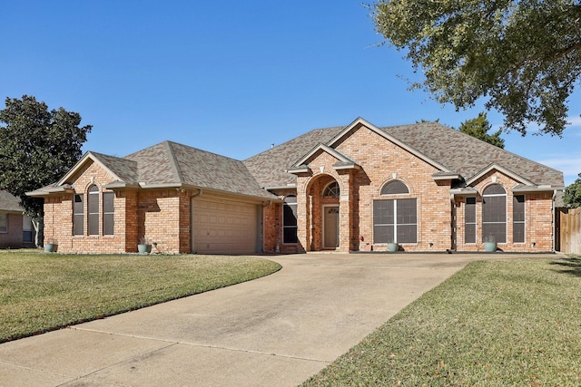 view of front of home featuring a garage and a front lawn