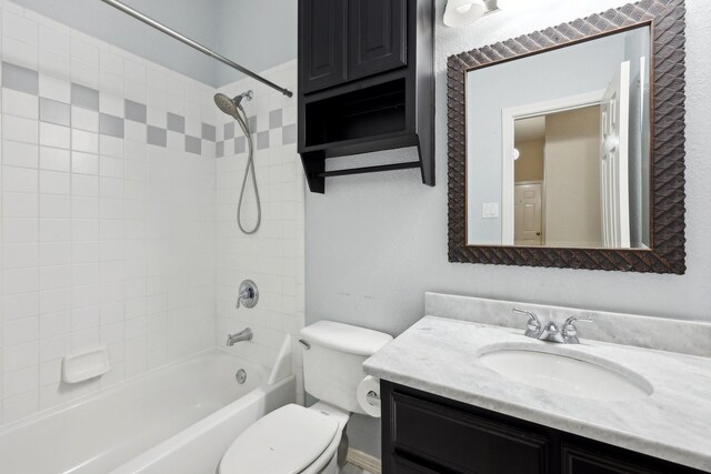 full bathroom featuring vanity, toilet, and tiled shower / bath combo