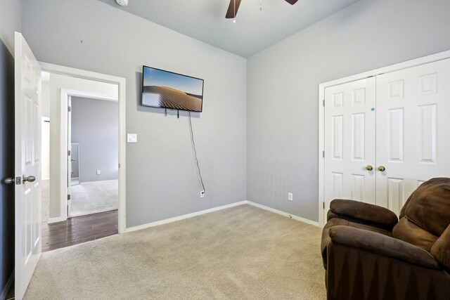 sitting room featuring light carpet and ceiling fan