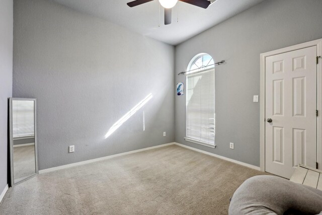 carpeted spare room with ceiling fan