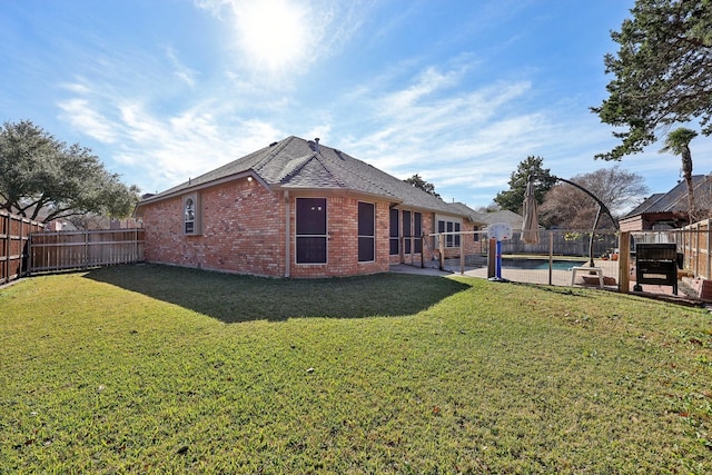 rear view of property with a lawn