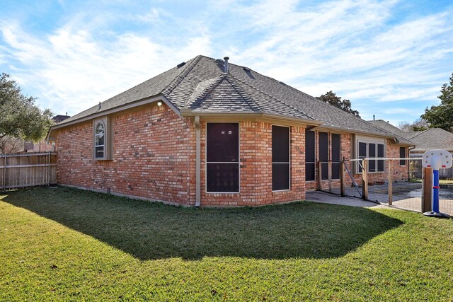 back of house with a yard and a patio area