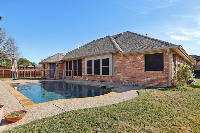 view of swimming pool featuring a lawn and a patio area