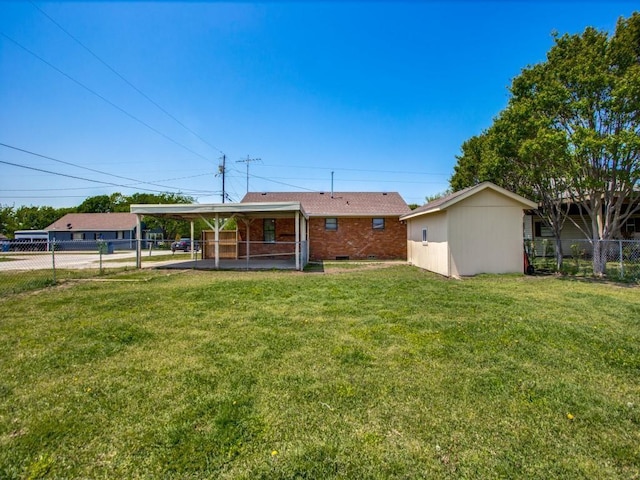 rear view of house with a lawn, a shed, and a carport