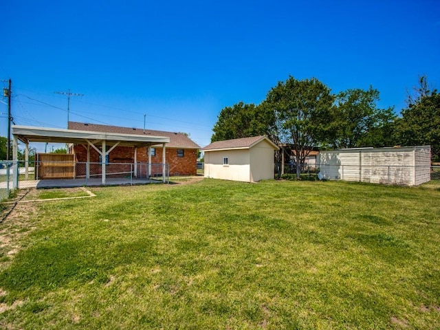 view of yard with an outbuilding and a carport