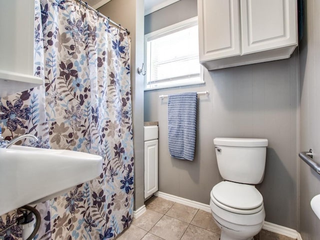 bathroom featuring sink, tile patterned floors, and toilet