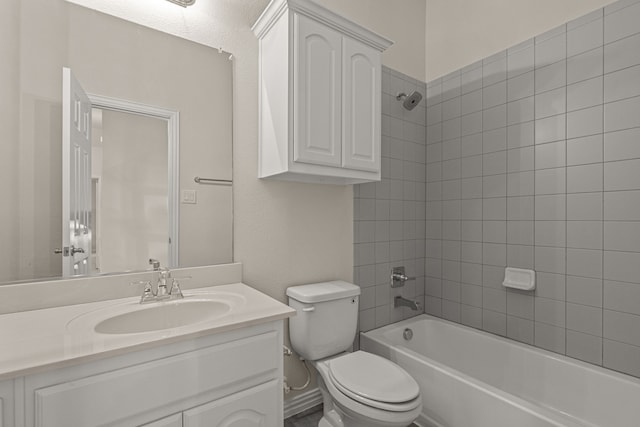 full bathroom featuring toilet, vanity, and tiled shower / bath