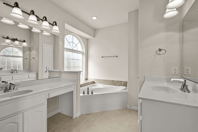 bathroom with a bathtub, vanity, and a healthy amount of sunlight