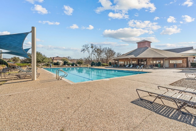 view of swimming pool featuring a patio area