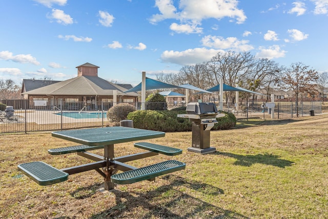 view of property's community with a patio area, a yard, and a pool