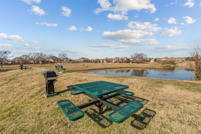 view of home's community featuring a yard and a water view