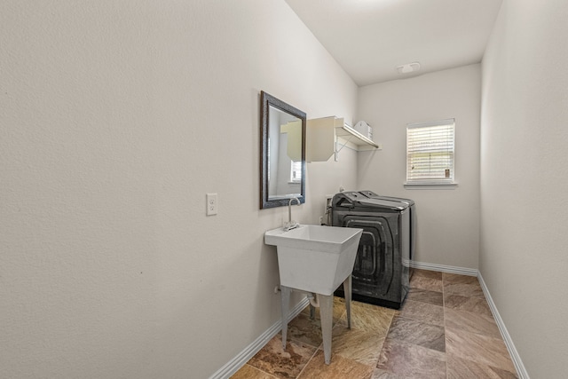 clothes washing area with washer / dryer