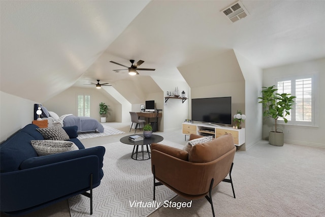 carpeted living room with ceiling fan and lofted ceiling