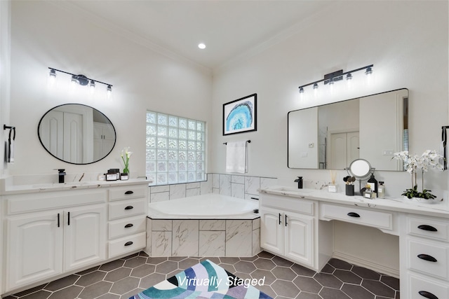 bathroom with tile patterned floors, vanity, ornamental molding, and tiled tub