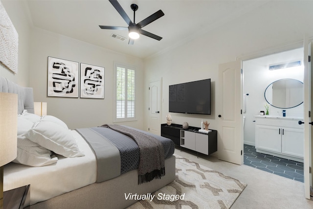 carpeted bedroom featuring ceiling fan, crown molding, and connected bathroom