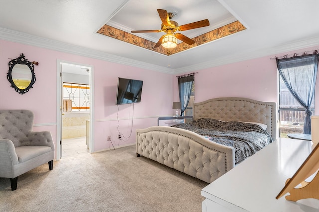 bedroom with crown molding, ceiling fan, connected bathroom, a tray ceiling, and light colored carpet