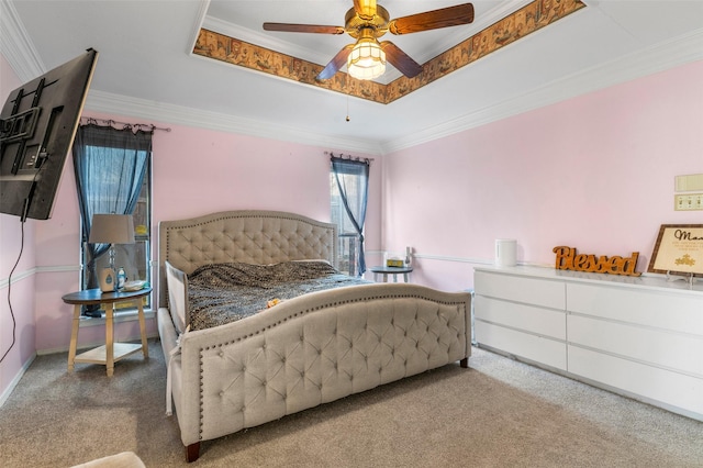 bedroom featuring a raised ceiling, ceiling fan, and ornamental molding