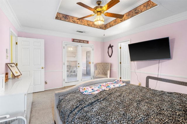 bedroom with a tray ceiling, ceiling fan, light colored carpet, and ornamental molding