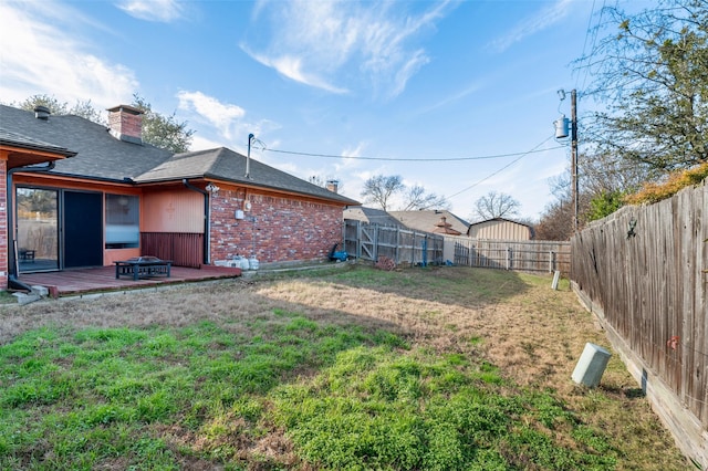 view of yard featuring a fire pit and a deck