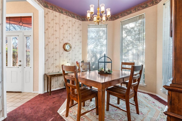 dining space with a chandelier and light colored carpet