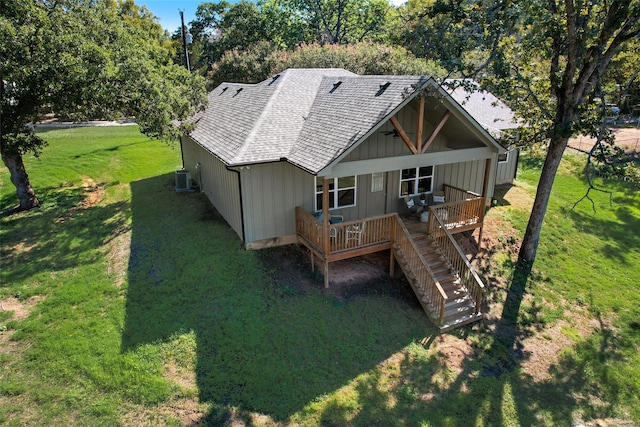 back of house with central AC, a yard, and a deck