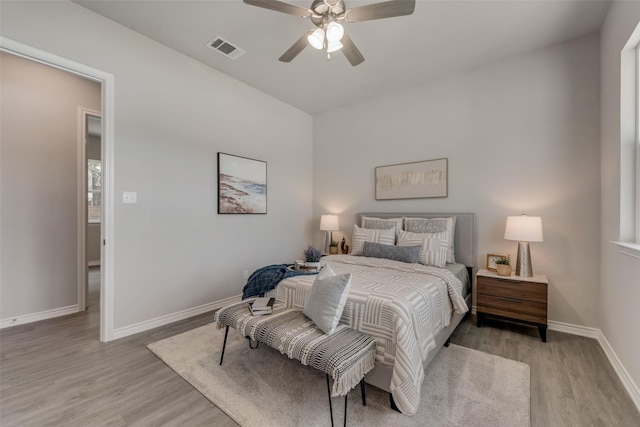 bedroom with ceiling fan and light wood-type flooring