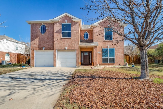 view of front of property with a garage and central AC