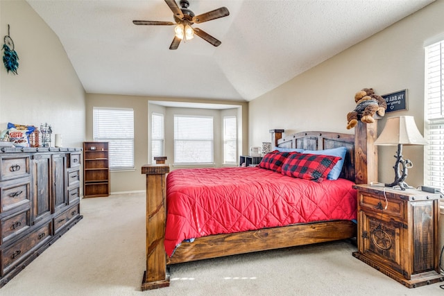 bedroom featuring ceiling fan, lofted ceiling, light carpet, and multiple windows