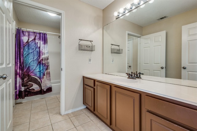 bathroom with tile patterned flooring, vanity, shower / bath combination with curtain, and a textured ceiling