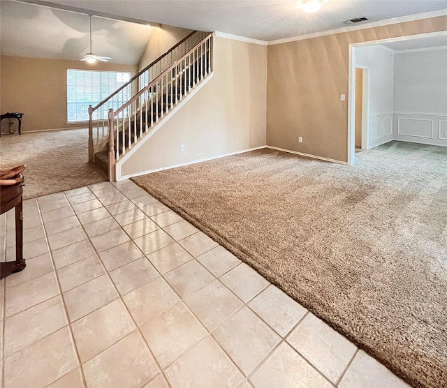 unfurnished living room with carpet flooring, ceiling fan, vaulted ceiling, and ornamental molding