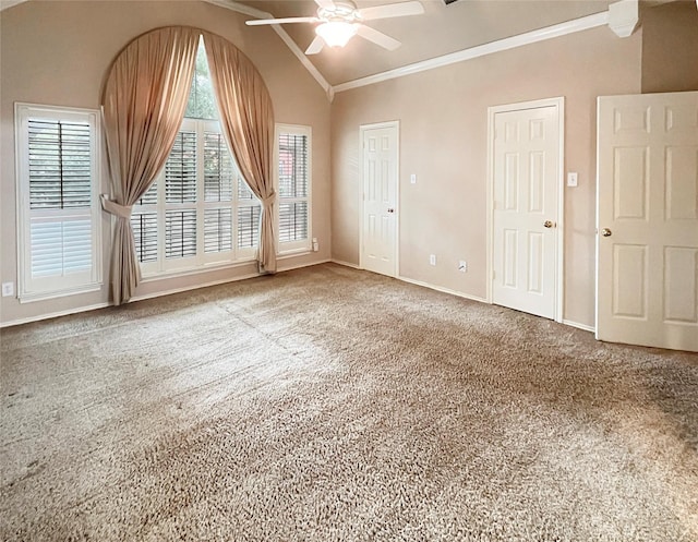 spare room with carpet flooring, ceiling fan, crown molding, and vaulted ceiling