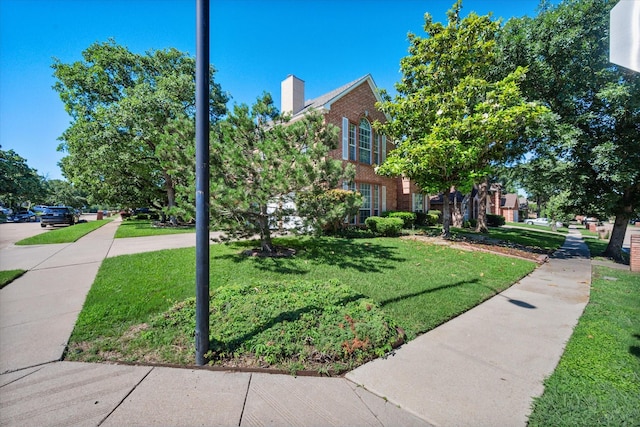 view of property's community with a lawn