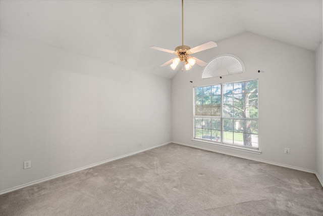 carpeted spare room featuring ceiling fan and high vaulted ceiling