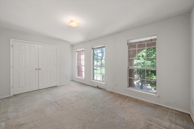 unfurnished room with light carpet