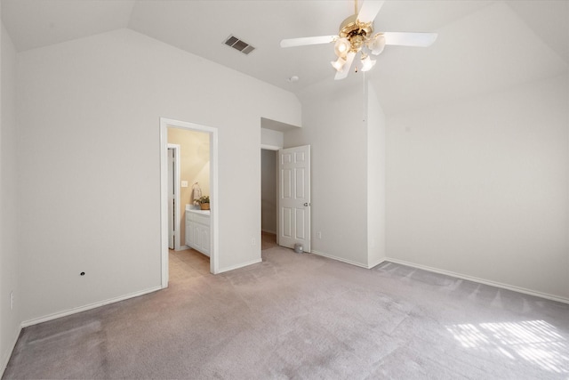 unfurnished bedroom featuring ceiling fan, lofted ceiling, light carpet, and ensuite bath