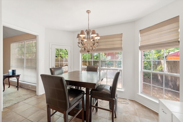 dining space featuring light tile patterned floors, an inviting chandelier, and plenty of natural light