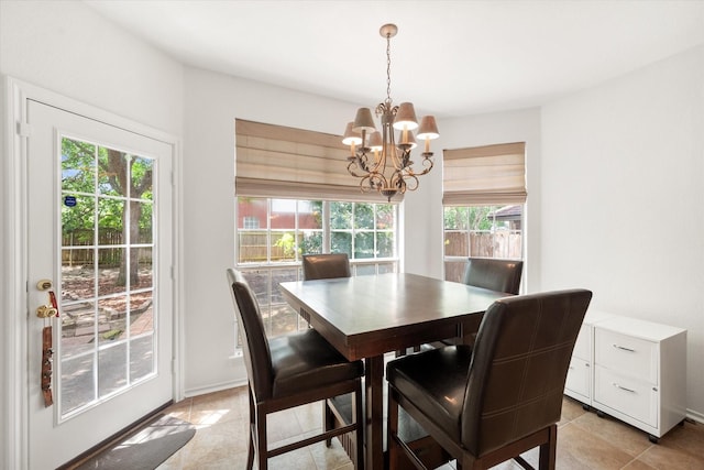 dining area with a healthy amount of sunlight, light tile patterned floors, and a chandelier