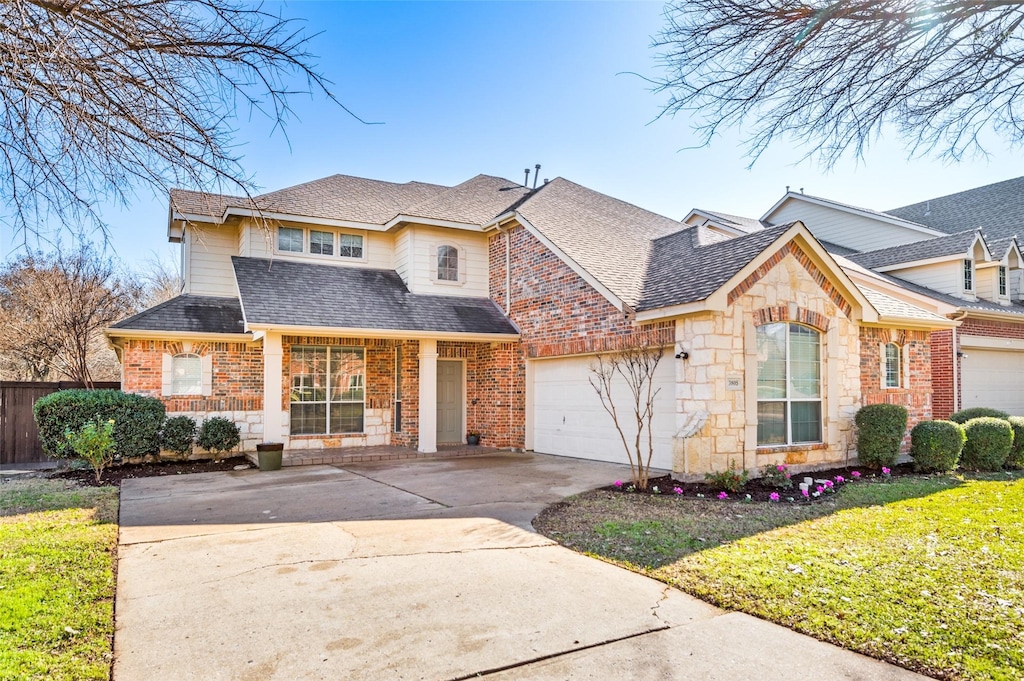 view of front property featuring a garage and a front lawn