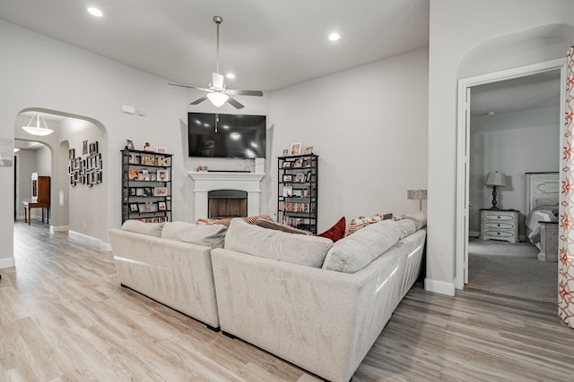 living room with ceiling fan and light hardwood / wood-style floors