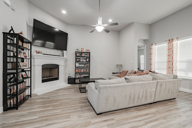 living room featuring ceiling fan and light hardwood / wood-style flooring