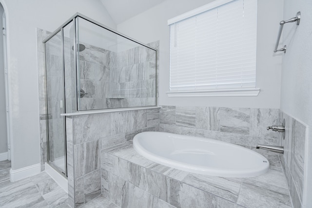 bathroom featuring plus walk in shower and vaulted ceiling