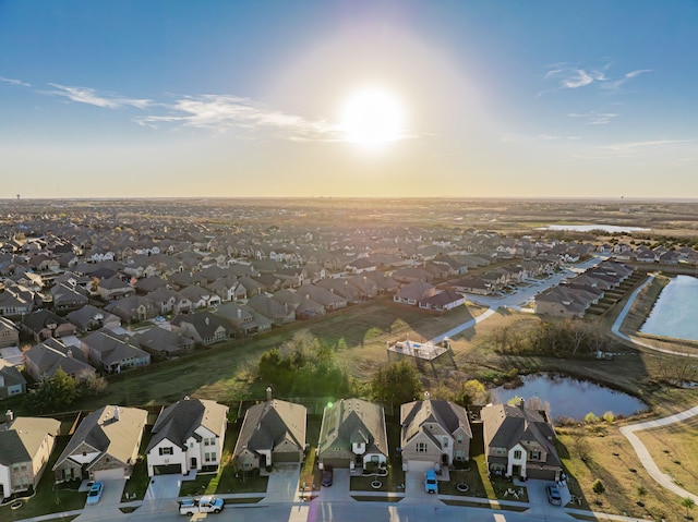 aerial view at dusk with a water view