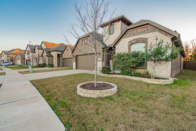 view of front of home with a front lawn and a garage