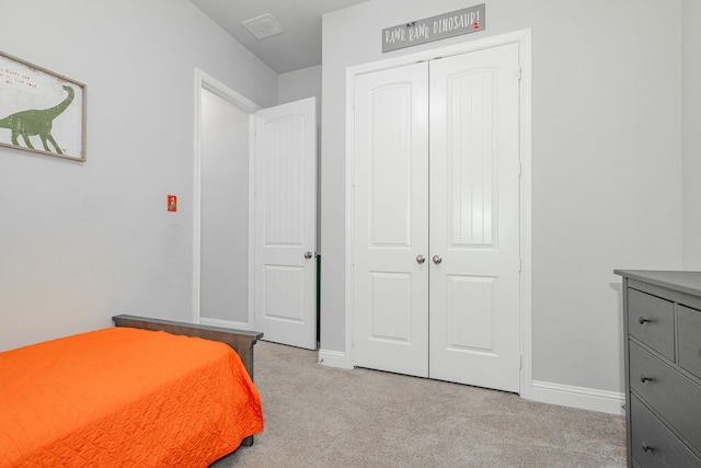 bedroom with light colored carpet and a closet