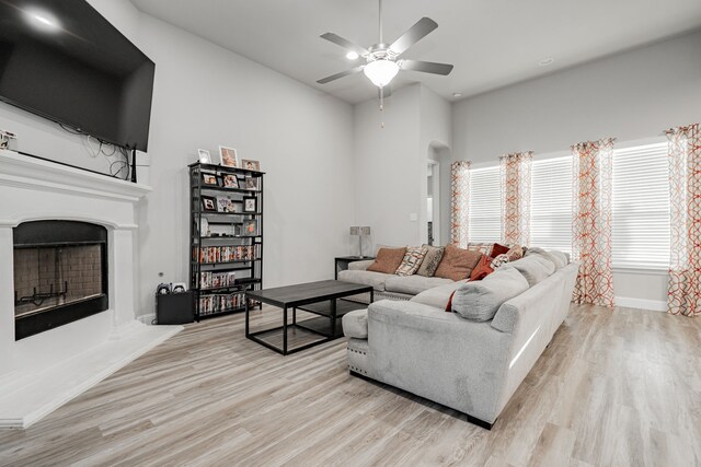 living room with ceiling fan and light hardwood / wood-style flooring