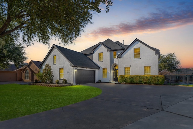 view of front facade featuring a lawn and a garage