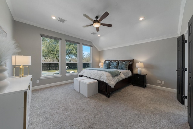 bedroom with ornamental molding, light colored carpet, ceiling fan, and vaulted ceiling