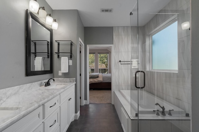 bathroom featuring plus walk in shower, tile patterned floors, and vanity