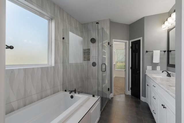 bathroom featuring independent shower and bath, tile patterned floors, and vanity